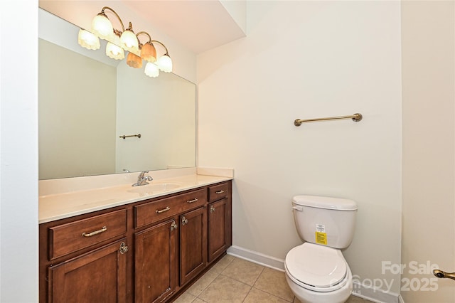 bathroom with toilet, tile patterned flooring, baseboards, and vanity