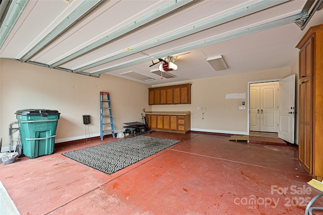 garage featuring baseboards and a garage door opener