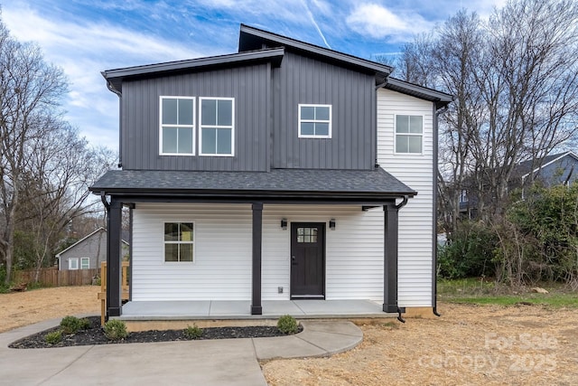 view of front of house featuring covered porch, a shingled roof, fence, and board and batten siding