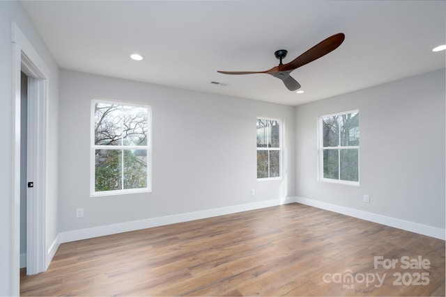 empty room featuring recessed lighting, visible vents, baseboards, and wood finished floors