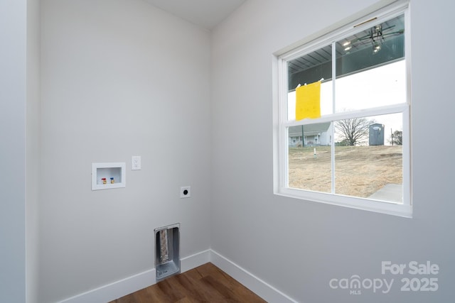 laundry room featuring laundry area, baseboards, dark wood-type flooring, hookup for a washing machine, and electric dryer hookup