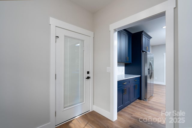 interior space with baseboards and light wood finished floors