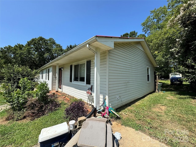 view of side of home featuring a lawn