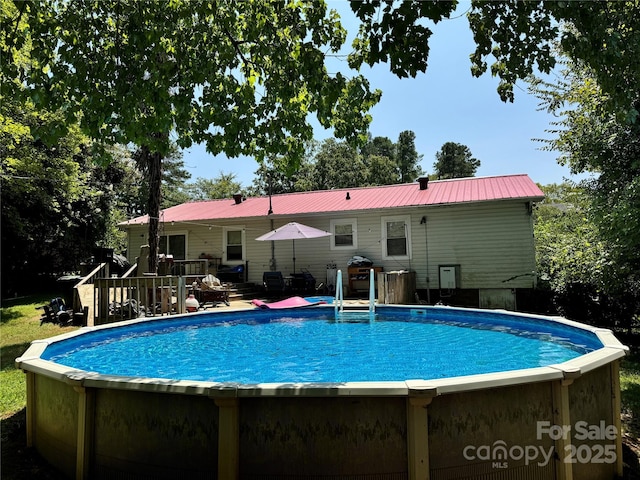 view of pool with a fenced in pool and a deck