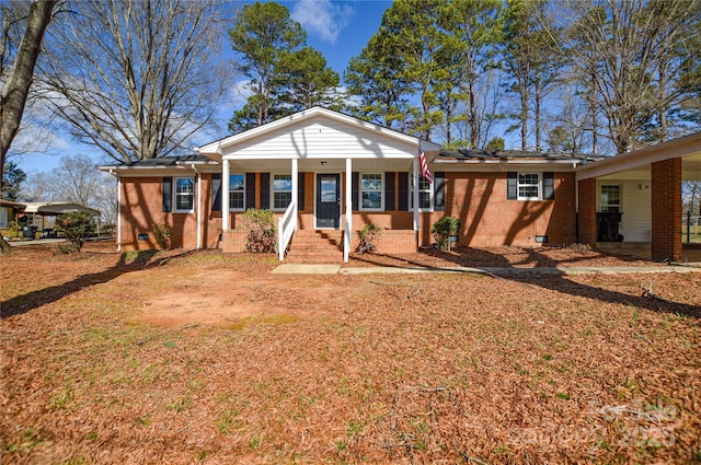 view of front of property with crawl space and brick siding