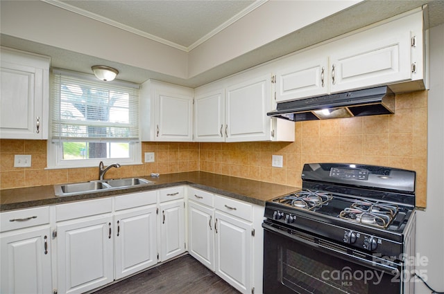 kitchen featuring dark countertops, under cabinet range hood, a sink, and black gas range oven