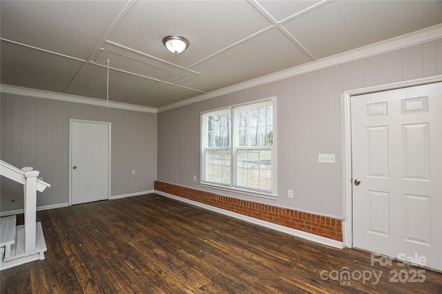 interior space with baseboards, wood-type flooring, and crown molding