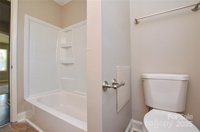 full bath featuring toilet and baseboards