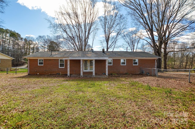 back of property featuring crawl space, a yard, fence, and french doors