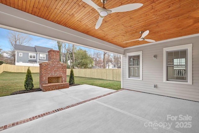 view of patio with an outdoor brick fireplace, a ceiling fan, and a fenced backyard