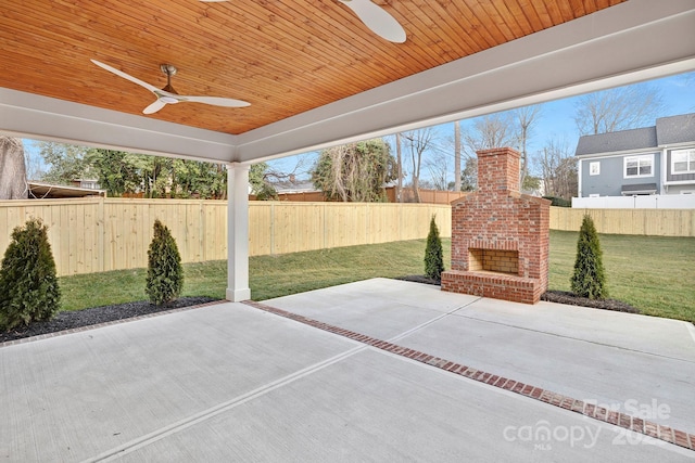 view of patio / terrace with an outdoor brick fireplace, a fenced backyard, and ceiling fan