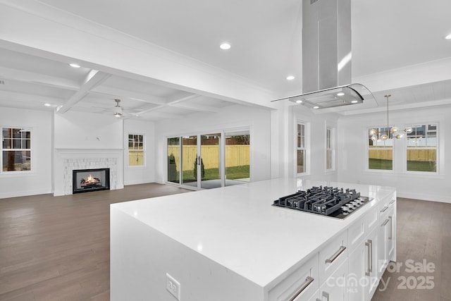 kitchen featuring island range hood, dark wood-style flooring, coffered ceiling, beam ceiling, and stainless steel gas stovetop