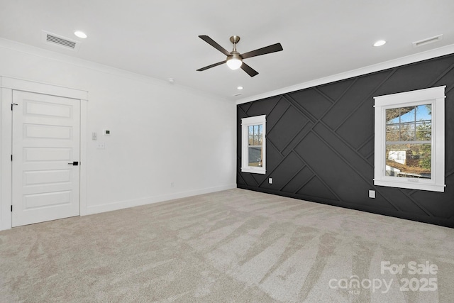 spare room with plenty of natural light, carpet, and crown molding