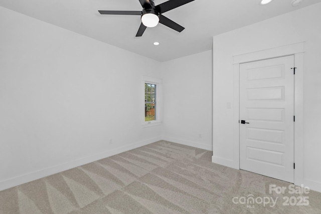 spare room with a ceiling fan, recessed lighting, carpet flooring, and baseboards