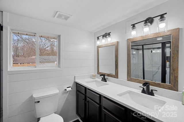 full bathroom with visible vents, a shower stall, toilet, and a sink