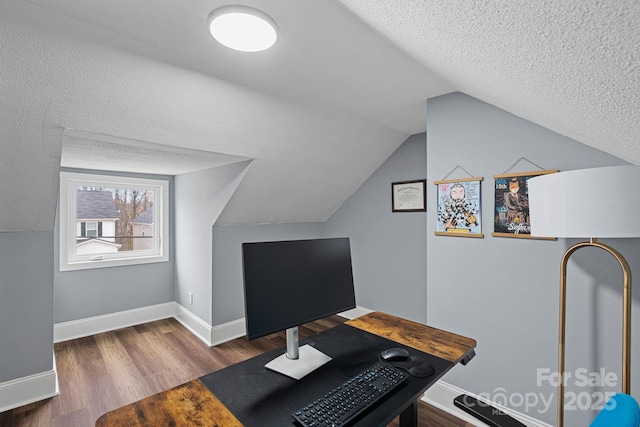 home office with lofted ceiling, wood finished floors, baseboards, and a textured ceiling