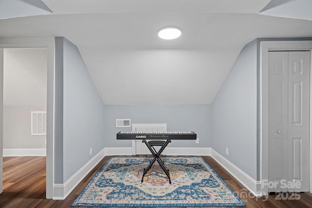 office with dark wood finished floors, visible vents, and baseboards