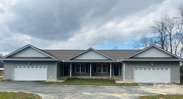 ranch-style home with a shingled roof, driveway, and an attached garage