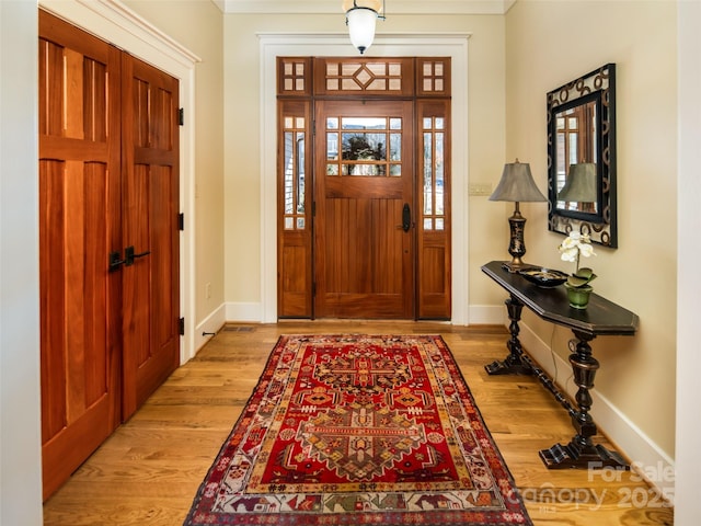 entryway with wood finished floors and baseboards