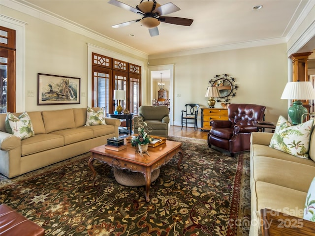 living area with a ceiling fan, crown molding, and wood finished floors