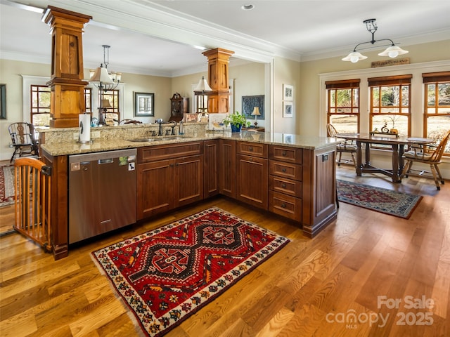 kitchen featuring crown molding, a healthy amount of sunlight, dishwasher, and a sink