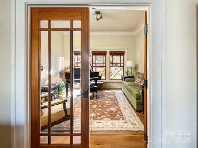 interior space featuring ornamental molding, wood finished floors, and french doors