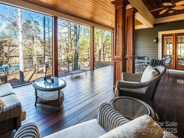 sunroom with ornate columns, wood ceiling, ceiling fan, and beamed ceiling