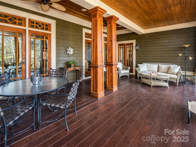 deck with outdoor dining area, ceiling fan, and outdoor lounge area