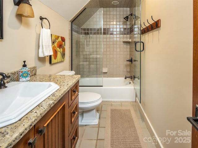 full bath featuring tile patterned floors, bathing tub / shower combination, toilet, and vanity