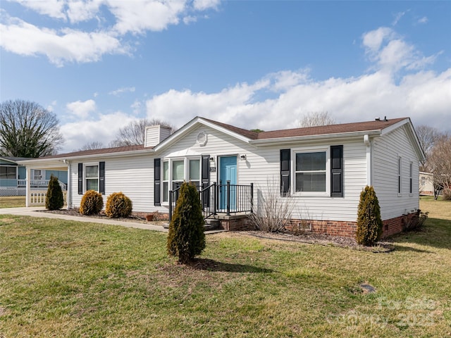 ranch-style home with crawl space, a chimney, and a front lawn