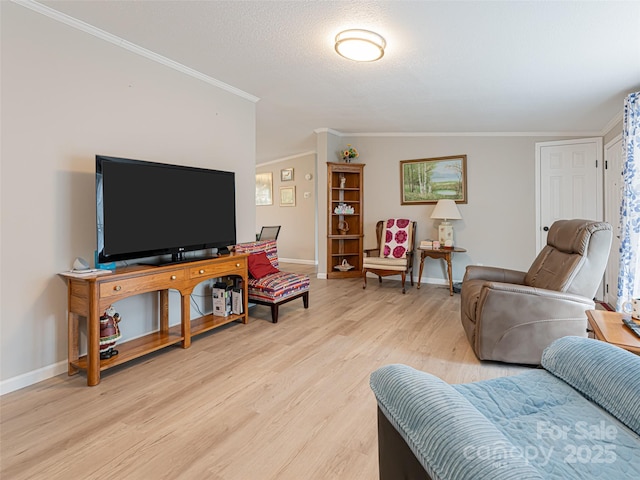 living area featuring crown molding, light wood-style flooring, baseboards, and a textured ceiling