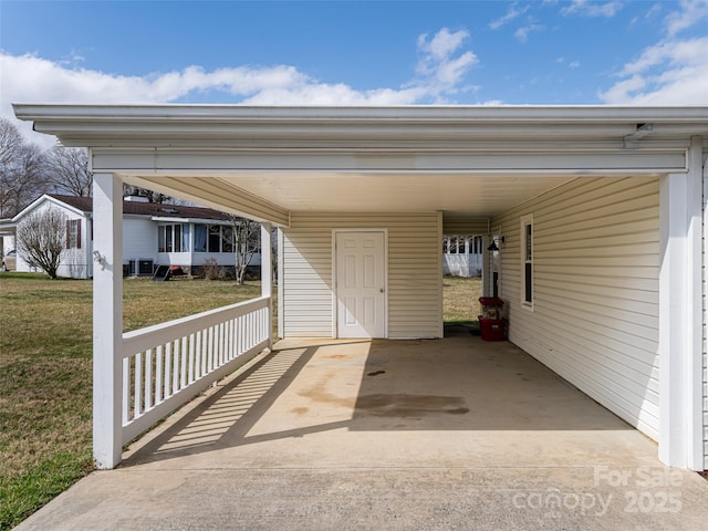 view of patio / terrace with an attached carport and driveway