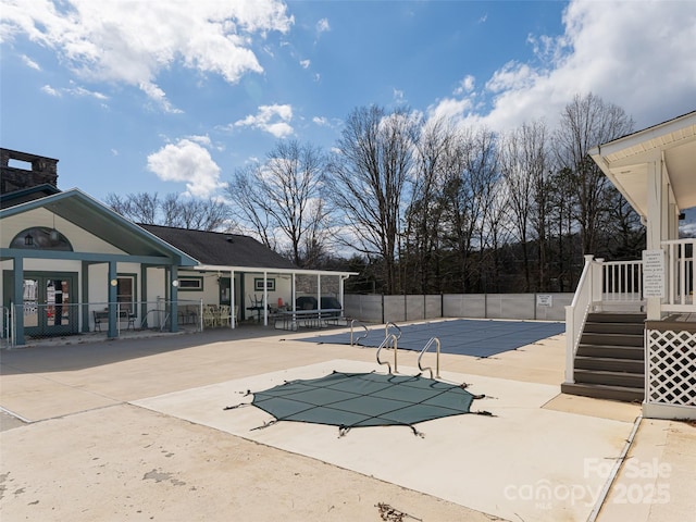 community pool featuring a patio area and fence