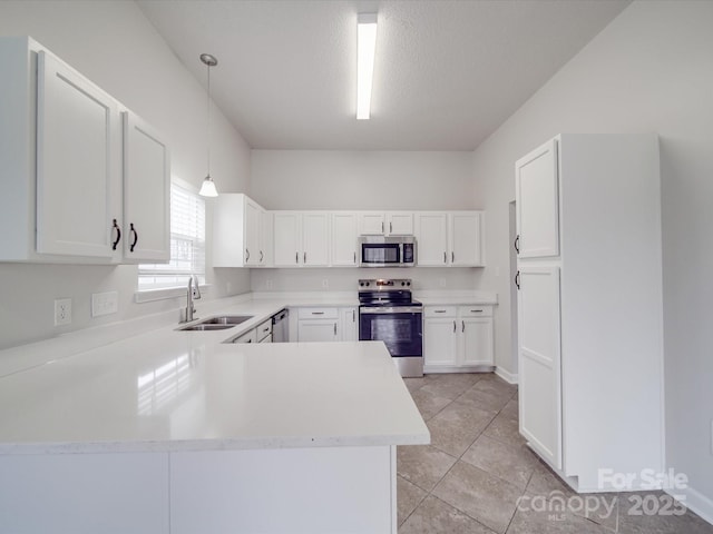 kitchen featuring white cabinetry, stainless steel appliances, a sink, and light countertops