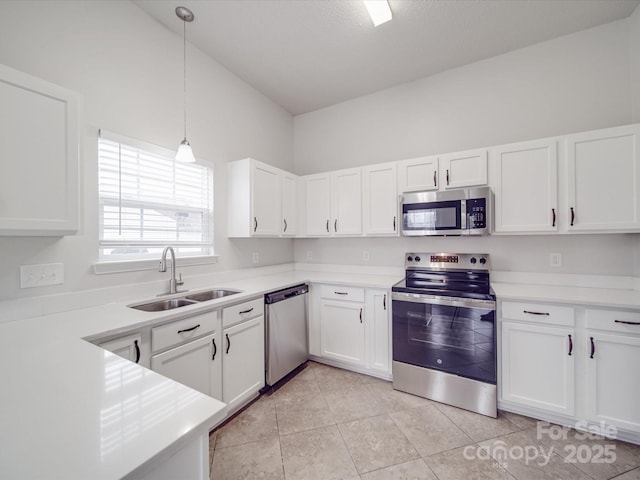 kitchen with stainless steel appliances, white cabinets, and a sink