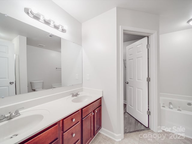 full bath with a garden tub, double vanity, tile patterned flooring, and a sink