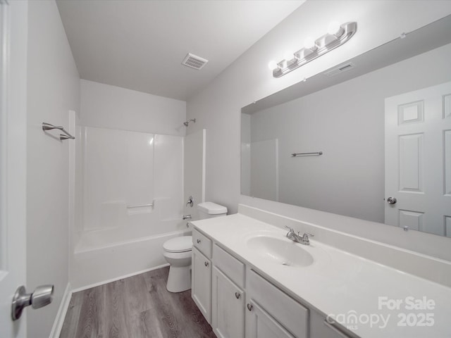 full bathroom with toilet, vanity, wood finished floors, and visible vents