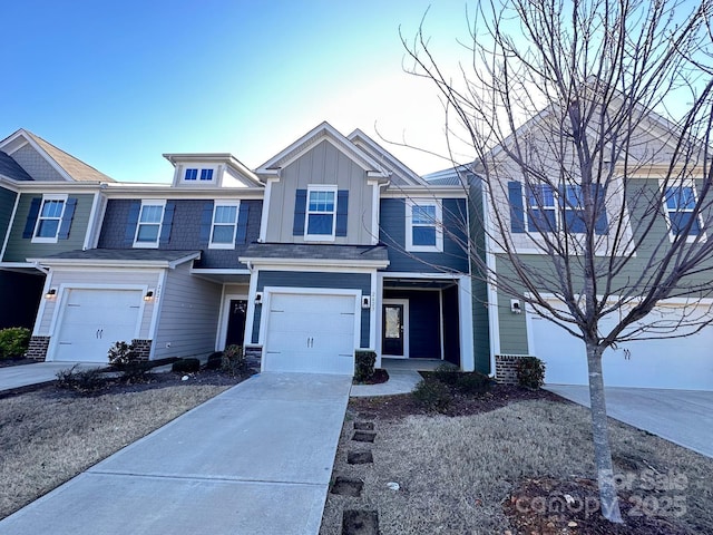 multi unit property with a garage, board and batten siding, and concrete driveway