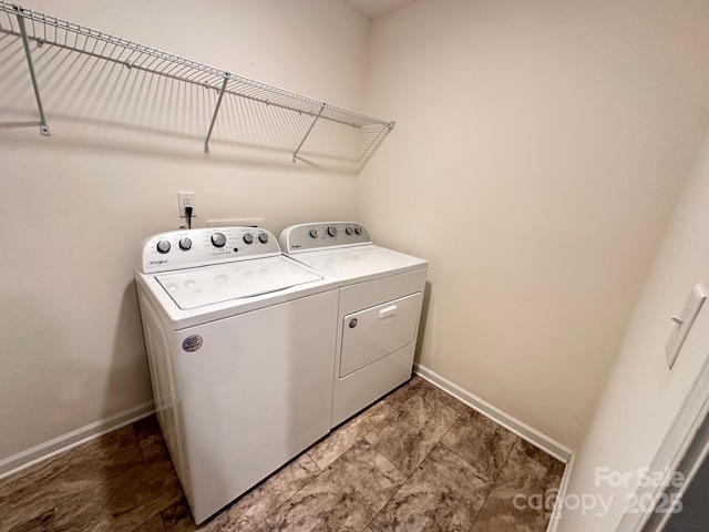 laundry room featuring laundry area, washing machine and dryer, and baseboards