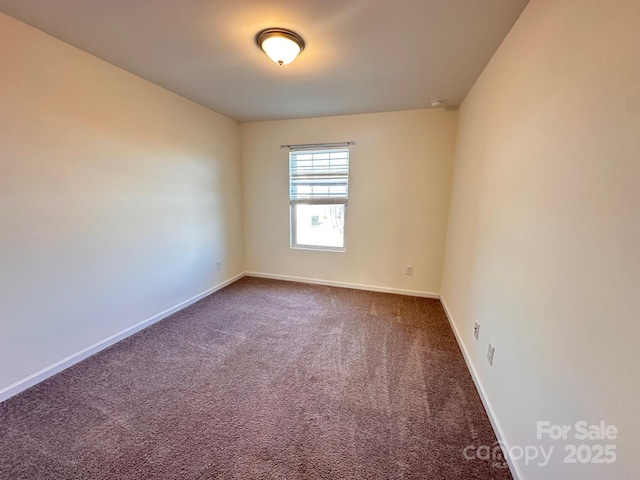 empty room with carpet floors and baseboards