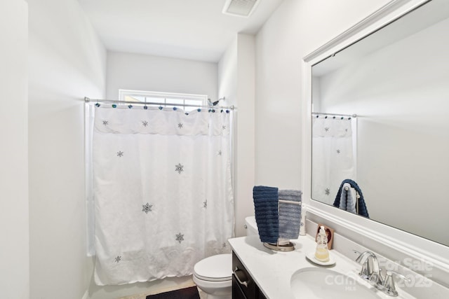 bathroom featuring visible vents, toilet, and vanity