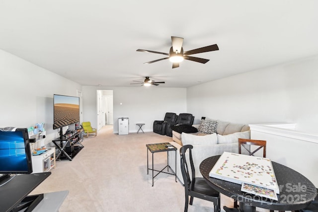 dining space featuring light colored carpet and ceiling fan