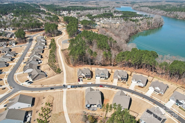 drone / aerial view featuring a residential view and a water view