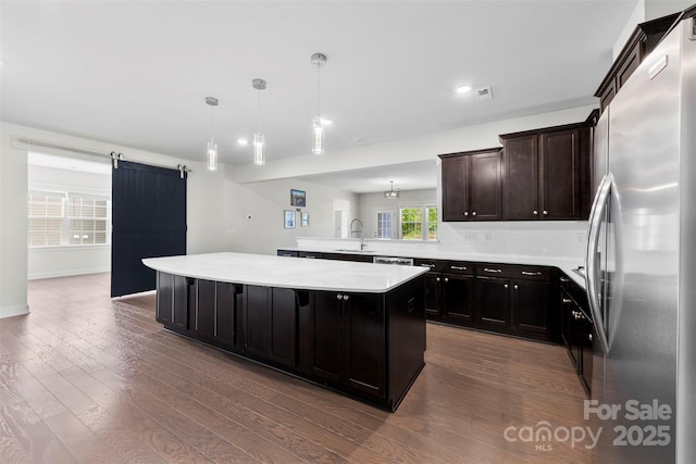 1300 Dali Blvd, Mount Holly, NC 28120 - kitchen with appliances with stainless steel finishes, a sink, light countertops, dark wood-type flooring, and a peninsula
