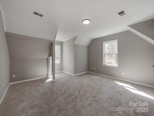 additional living space with a healthy amount of sunlight, baseboards, and visible vents