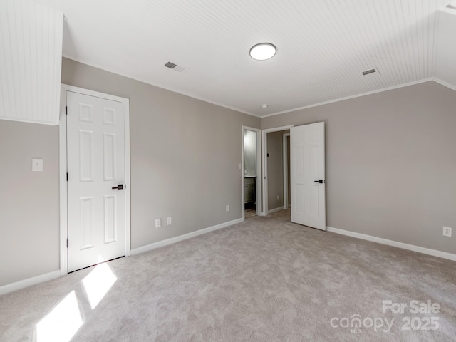 unfurnished bedroom with baseboards, carpet, visible vents, and crown molding