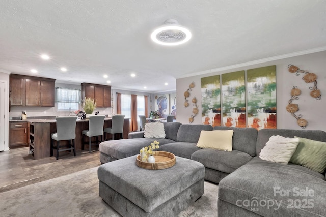 living room featuring ornamental molding and recessed lighting