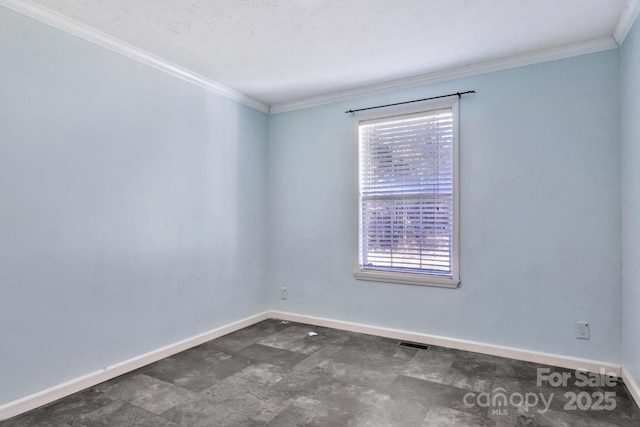 empty room with baseboards, visible vents, and ornamental molding