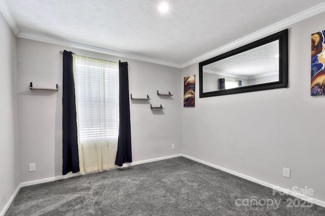 carpeted empty room with baseboards, visible vents, ornamental molding, and a textured ceiling