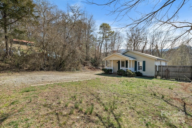 exterior space featuring fence and covered porch